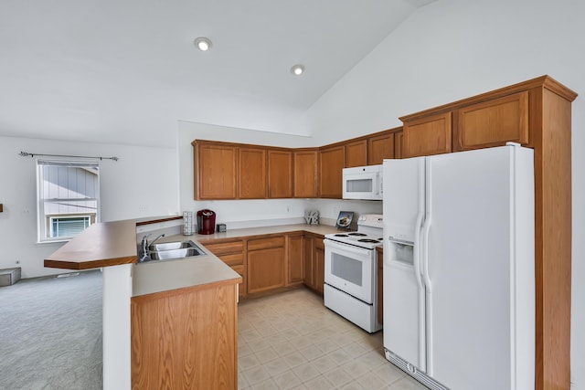5019 W W Prosperity Ln, Spokane, WA 99208 - kitchen with white appliances, a peninsula, high vaulted ceiling, brown cabinets, and recessed lighting