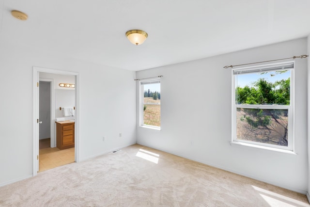 5019 W W Prosperity Ln, Spokane, WA 99208 - unfurnished bedroom featuring carpet flooring, multiple windows, and connected bathroom