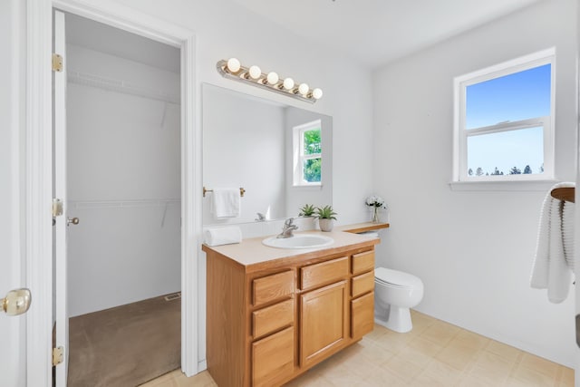 5019 W W Prosperity Ln, Spokane, WA 99208 - bathroom featuring vanity, a walk in closet, and tile patterned floors