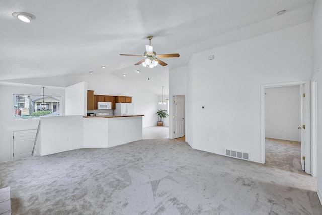 5019 W W Prosperity Ln, Spokane, WA 99208 - unfurnished living room featuring vaulted ceiling, light carpet, and a ceiling fan
