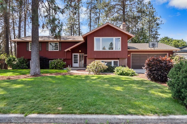 11905 N Atlantic St, Spokane, WA 99218 - bi-level home featuring an attached garage, a front yard, roof with shingles, and brick siding