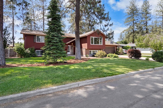 11905 N Atlantic St, Spokane, WA 99218 - raised ranch featuring a front lawn, an attached garage, and driveway