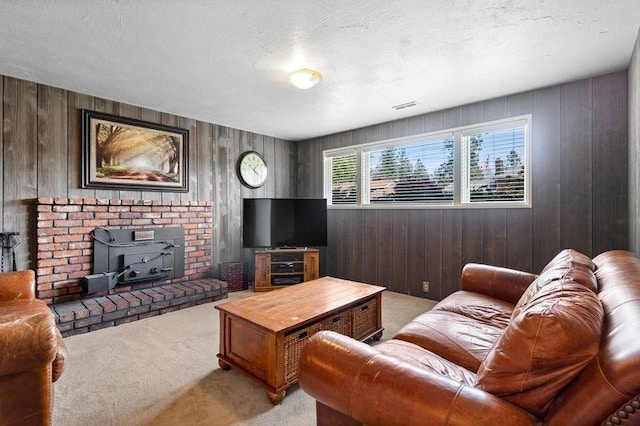 11905 N Atlantic St, Spokane, WA 99218 - living room with light carpet, a wood stove, and wood walls