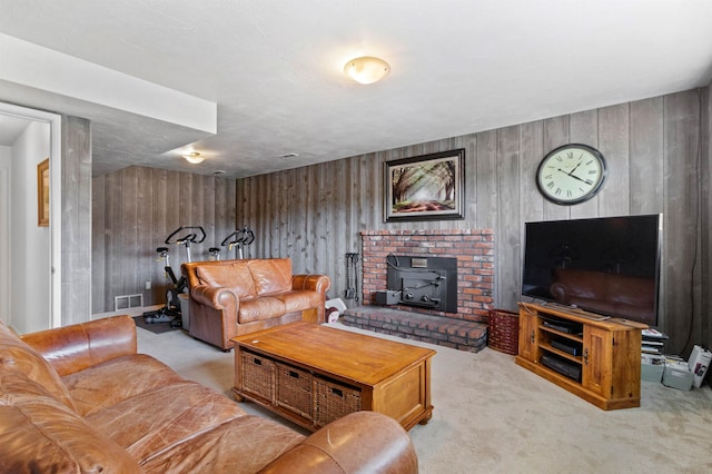 11905 N Atlantic St, Spokane, WA 99218 - living area featuring carpet, a wood stove, and wood walls