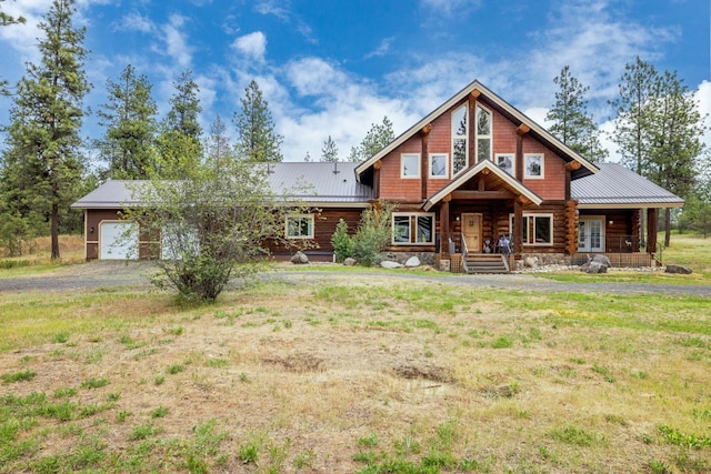 15611 W Pine Bluff Rd, Nine Mile Falls, WA 99026 - log home featuring a garage, dirt driveway, covered porch, and a metal roof