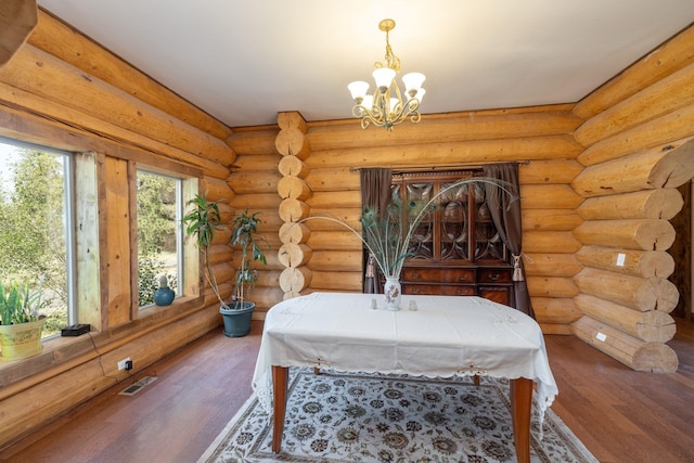 15611 W Pine Bluff Rd, Nine Mile Falls, WA 99026 - dining space featuring a chandelier, wood finished floors, and log walls