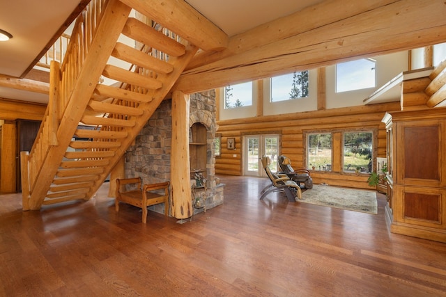 15611 W Pine Bluff Rd, Nine Mile Falls, WA 99026 - unfurnished living room featuring rustic walls, stairway, wood finished floors, and a high ceiling