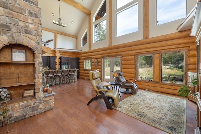 15611 W Pine Bluff Rd, Nine Mile Falls, WA 99026 - living area with high vaulted ceiling, healthy amount of natural light, rustic walls, beamed ceiling, and wood finished floors