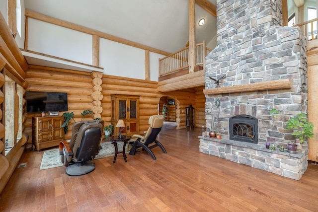15611 W Pine Bluff Rd, Nine Mile Falls, WA 99026 - living area featuring high vaulted ceiling, a stone fireplace, rustic walls, and wood finished floors