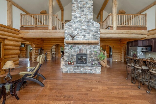 15611 W Pine Bluff Rd, Nine Mile Falls, WA 99026 - living area with high vaulted ceiling, rustic walls, wood finished floors, stairs, and beam ceiling