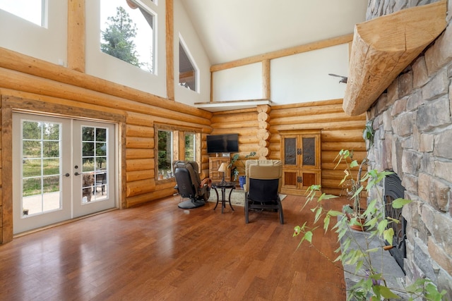15611 W Pine Bluff Rd, Nine Mile Falls, WA 99026 - sitting room with a high ceiling, french doors, wood finished floors, log walls, and a fireplace