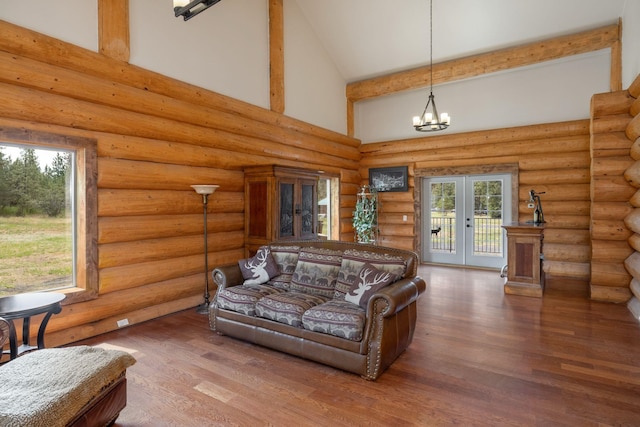 15611 W Pine Bluff Rd, Nine Mile Falls, WA 99026 - living area with high vaulted ceiling, wood finished floors, a chandelier, and french doors