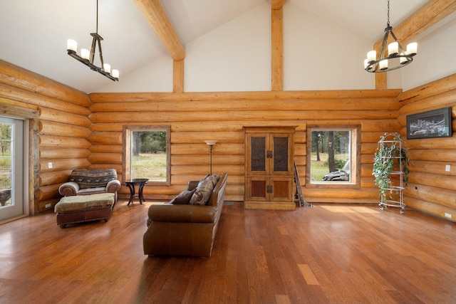 15611 W Pine Bluff Rd, Nine Mile Falls, WA 99026 - living room featuring high vaulted ceiling, beamed ceiling, wood finished floors, a chandelier, and log walls