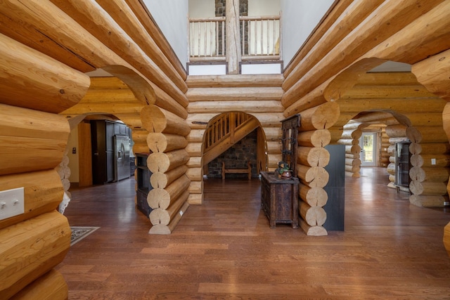 15611 W Pine Bluff Rd, Nine Mile Falls, WA 99026 - interior space featuring arched walkways, wood finished floors, and rustic walls