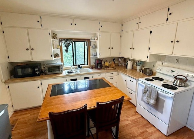 508 N Cedar St, Colville, WA 99114 - kitchen featuring black appliances, white cabinets, open shelves, backsplash, and light wood-type flooring
