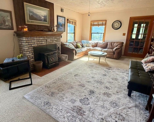 508 N Cedar St, Colville, WA 99114 - living area with a textured ceiling, carpet flooring, and a wood stove