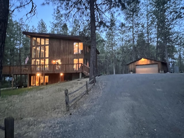 4605 W Pinto Rd, Cheney, WA 99004 - view of property exterior featuring a wooden deck, a detached garage, an outbuilding, and driveway