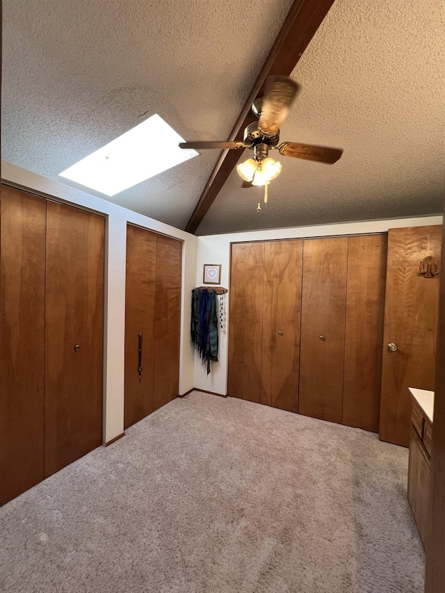 4605 W Pinto Rd, Cheney, WA 99004 - unfurnished bedroom featuring a skylight, carpet, a textured ceiling, two closets, and ceiling fan