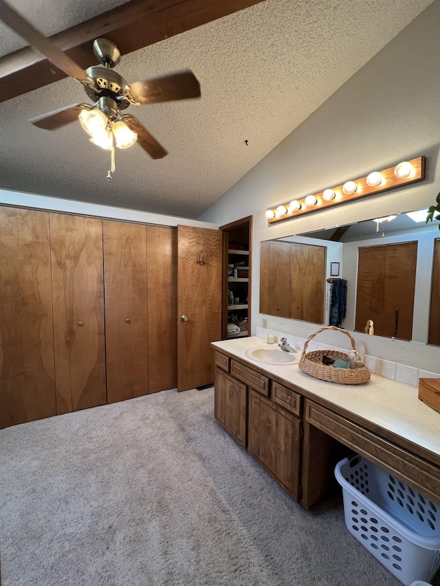 4605 W Pinto Rd, Cheney, WA 99004 - bathroom featuring lofted ceiling, vanity, ceiling fan, a textured ceiling, and carpet floors