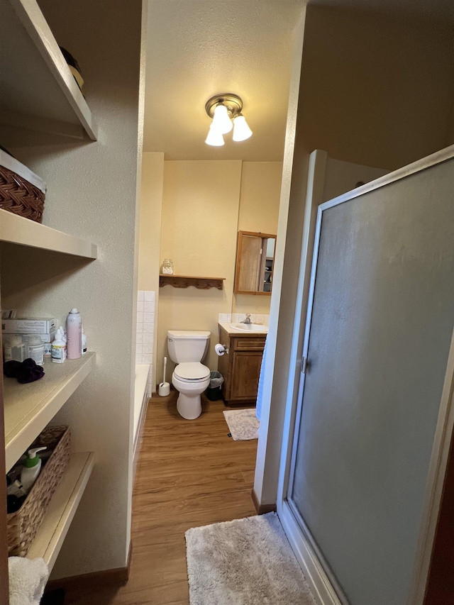 4605 W Pinto Rd, Cheney, WA 99004 - full bathroom featuring a shower with shower door, vanity, wood finished floors, and a bath
