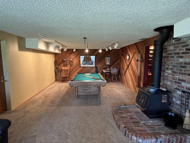 4605 W Pinto Rd, Cheney, WA 99004 - rec room featuring track lighting, a wood stove, carpet flooring, wooden walls, and billiards