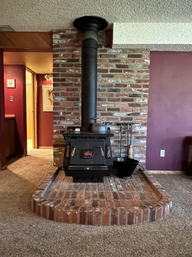 4605 W Pinto Rd, Cheney, WA 99004 - detailed view of a wood stove, carpet floors, and a textured ceiling