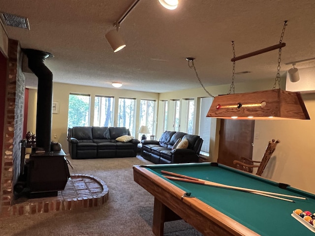 4605 W Pinto Rd, Cheney, WA 99004 - recreation room featuring a wood stove, carpet, a textured ceiling, and billiards