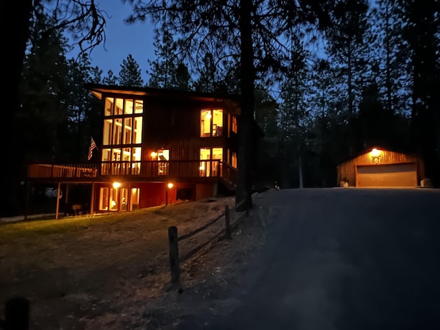 4605 W Pinto Rd, Cheney, WA 99004 - view of front of house featuring an outdoor structure, a detached garage, a wooden deck, and driveway