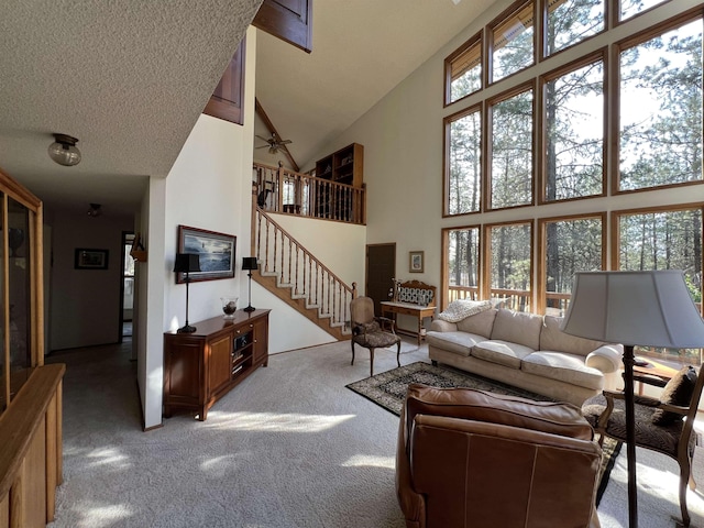 4605 W Pinto Rd, Cheney, WA 99004 - living room with high vaulted ceiling, light colored carpet, healthy amount of natural light, and stairs