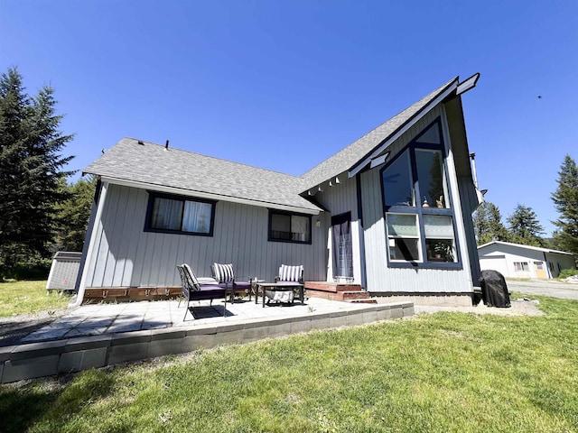 1572 E 20th Hwy, Colville, WA 99114 - back of property with roof with shingles, a lawn, and a patio area
