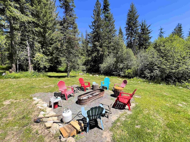 1572 E 20th Hwy, Colville, WA 99114 - view of green lawn featuring an outdoor fire pit and a view of trees