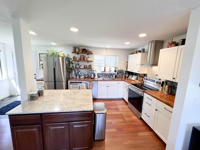 1572 E 20th Hwy, Colville, WA 99114 - kitchen featuring stainless steel appliances, white cabinetry, decorative backsplash, light wood-style flooring, and recessed lighting