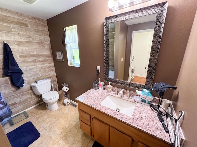 1572 E 20th Hwy, Colville, WA 99114 - bathroom with vanity, tile patterned flooring, an accent wall, and tile walls
