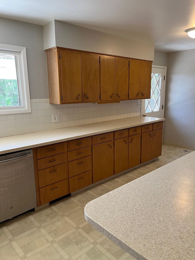 10520 N College Cir, Spokane, WA 99218 - kitchen featuring dishwasher, brown cabinets, and light countertops