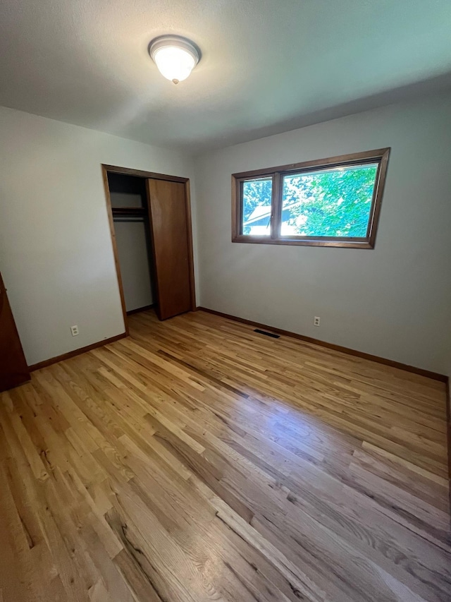 10520 N College Cir, Spokane, WA 99218 - unfurnished bedroom with light wood-style floors and a closet