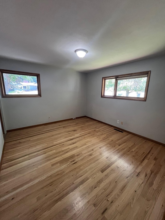 10520 N College Cir, Spokane, WA 99218 - spare room featuring wood finished floors and baseboards