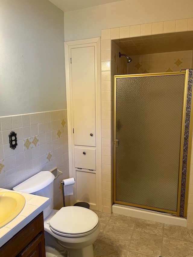 10520 N College Cir, Spokane, WA 99218 - bathroom featuring a shower stall, vanity, and tile walls