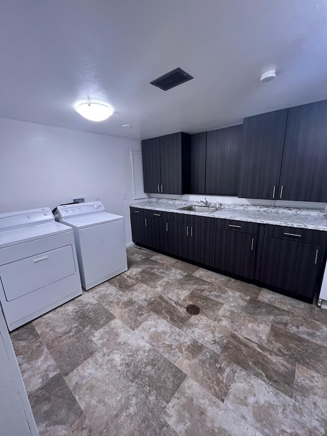 10520 N College Cir, Spokane, WA 99218 - laundry room featuring cabinet space, separate washer and dryer, and stone finish floors
