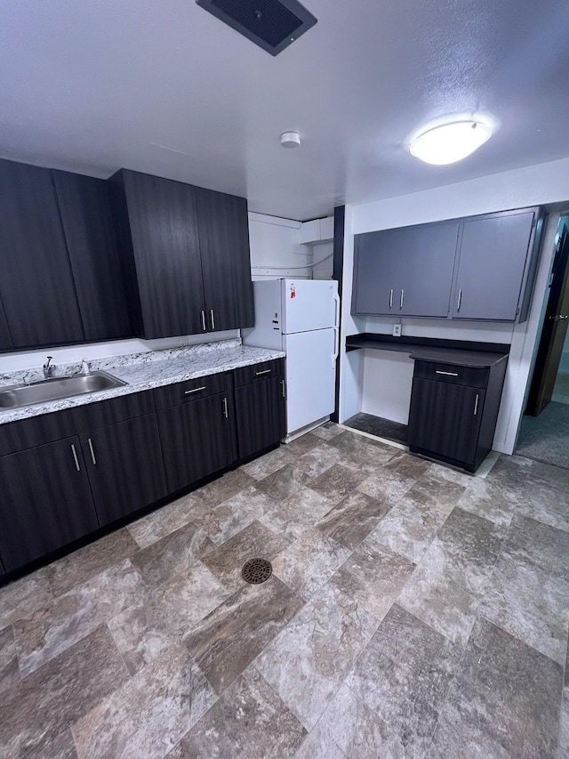 10520 N College Cir, Spokane, WA 99218 - kitchen featuring freestanding refrigerator and stone finish floors
