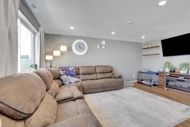 4538 W Brookfield Ave, Spokane, WA 99208 - living area with wood finished floors, recessed lighting, and a textured ceiling