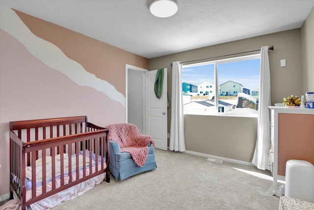 4538 W Brookfield Ave, Spokane, WA 99208 - bedroom with carpet flooring, a textured ceiling, and a nursery area