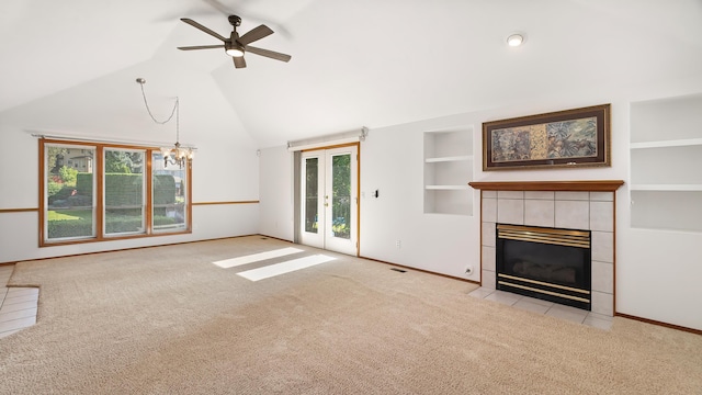 1220 E Brierwood Dr, Spokane, WA 99218 - unfurnished living room featuring carpet, plenty of natural light, ceiling fan, a tiled fireplace, and high vaulted ceiling
