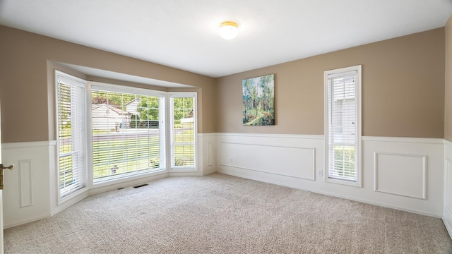 1220 E Brierwood Dr, Spokane, WA 99218 - unfurnished room featuring a wainscoted wall and carpet