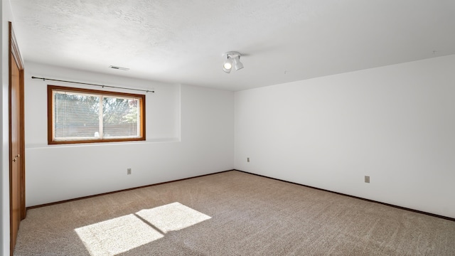 1220 E Brierwood Dr, Spokane, WA 99218 - carpeted spare room featuring baseboards and a textured ceiling