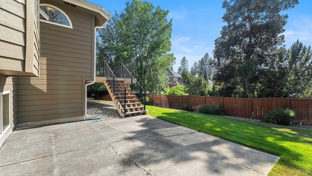 1220 E Brierwood Dr, Spokane, WA 99218 - fenced backyard featuring a patio and stairway