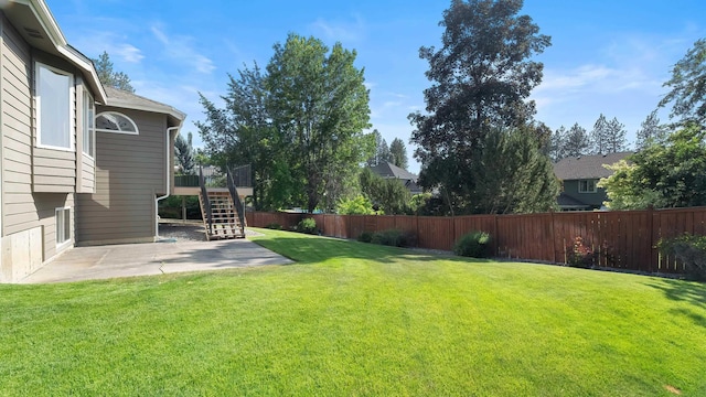 1220 E Brierwood Dr, Spokane, WA 99218 - fenced backyard with a patio area and stairway