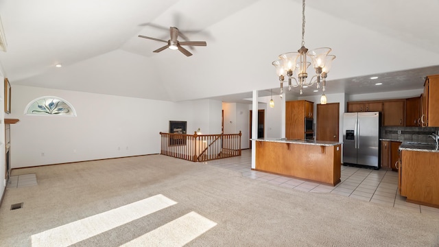 1220 E Brierwood Dr, Spokane, WA 99218 - kitchen with stainless steel fridge, light colored carpet, open floor plan, a chandelier, and light tile patterned flooring