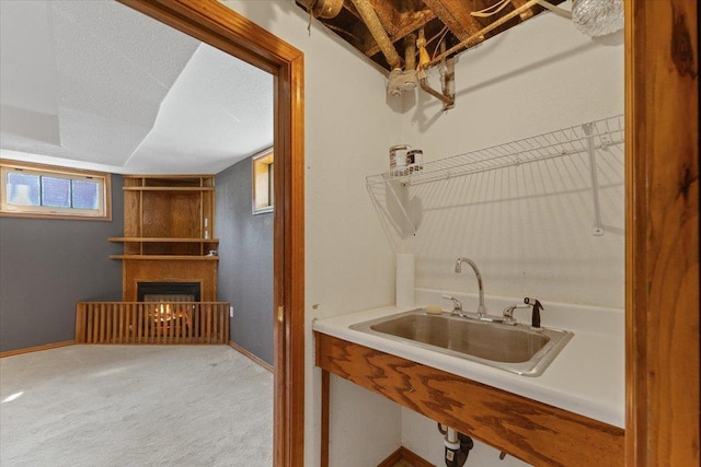 4303 W Crown Ave, Spokane, WA 99205 - washroom featuring a warm lit fireplace and carpet floors