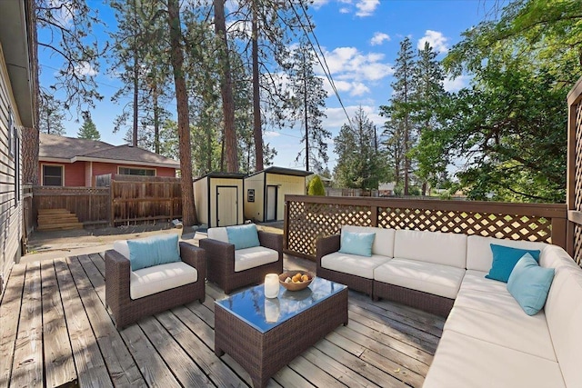 4303 W Crown Ave, Spokane, WA 99205 - wooden deck featuring outdoor lounge area, a storage unit, and a fenced backyard