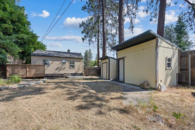 4303 W Crown Ave, Spokane, WA 99205 - back of property with a wooden deck, a garage, and an outdoor structure